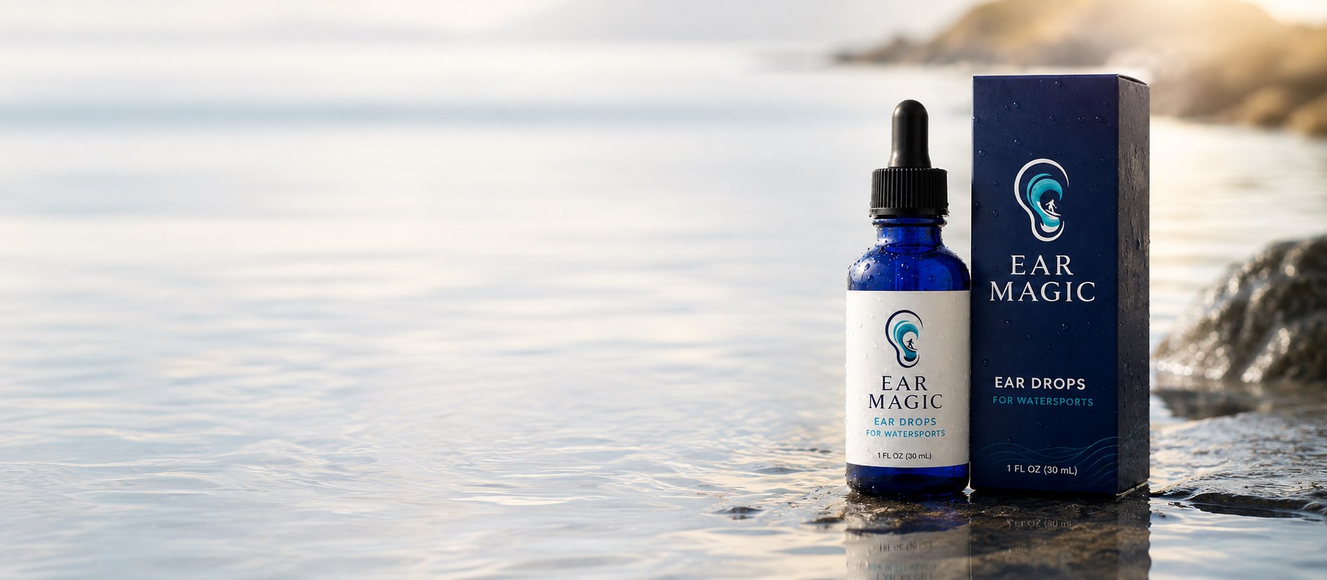 Ear Magic dropper bottle and packaging on a rocky shoreline at first light